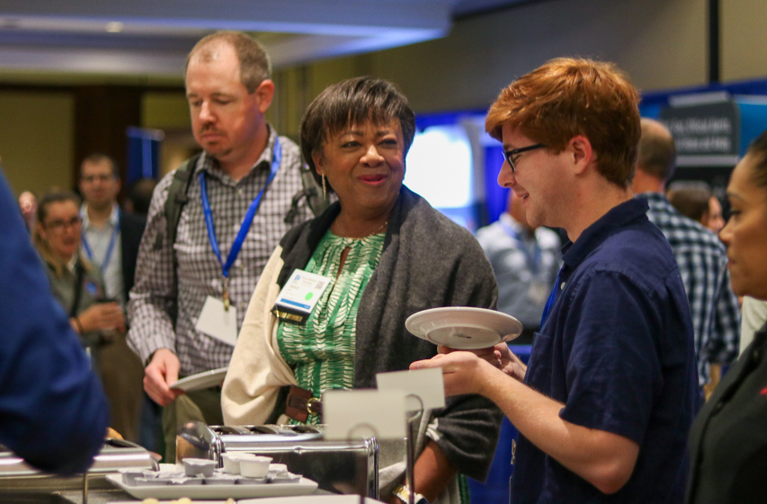 NWA Annual Meeting attendees talk in the exhibitor hall.